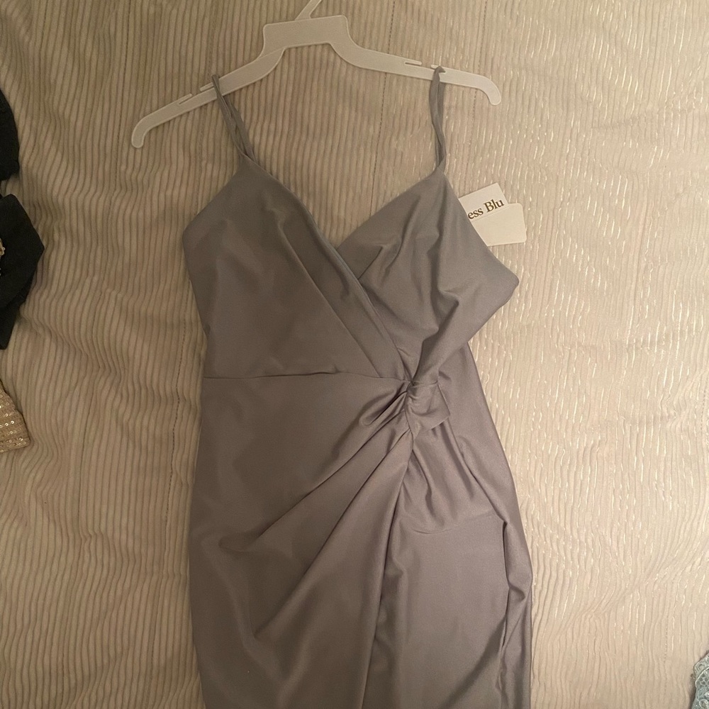 A dance dress that has never been worn before. The tags are still on it.